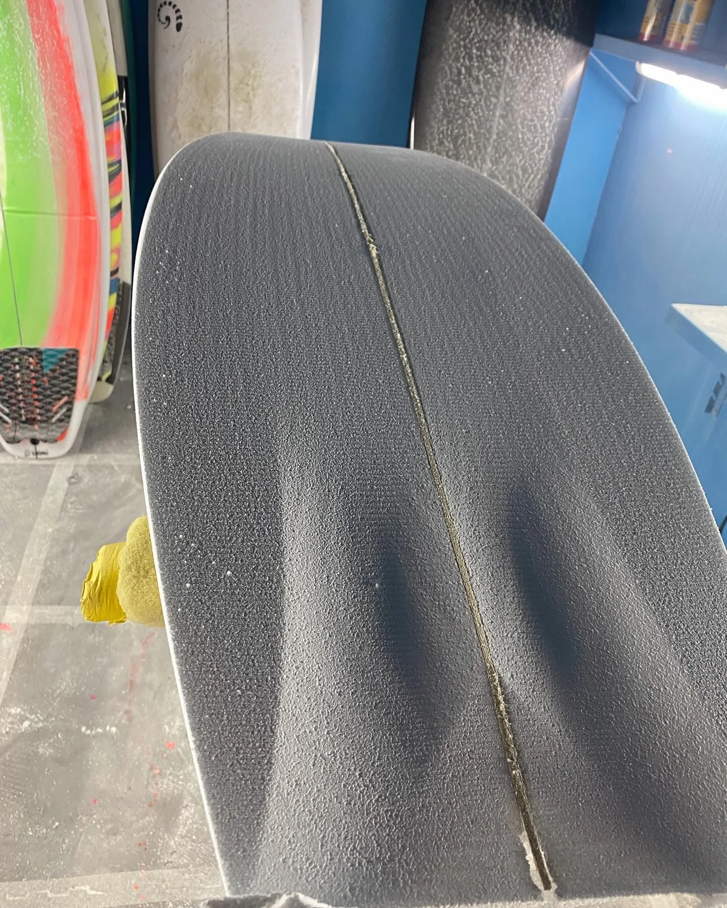 Close-up of a shaped foam blank with wooden stringer, pre-glass