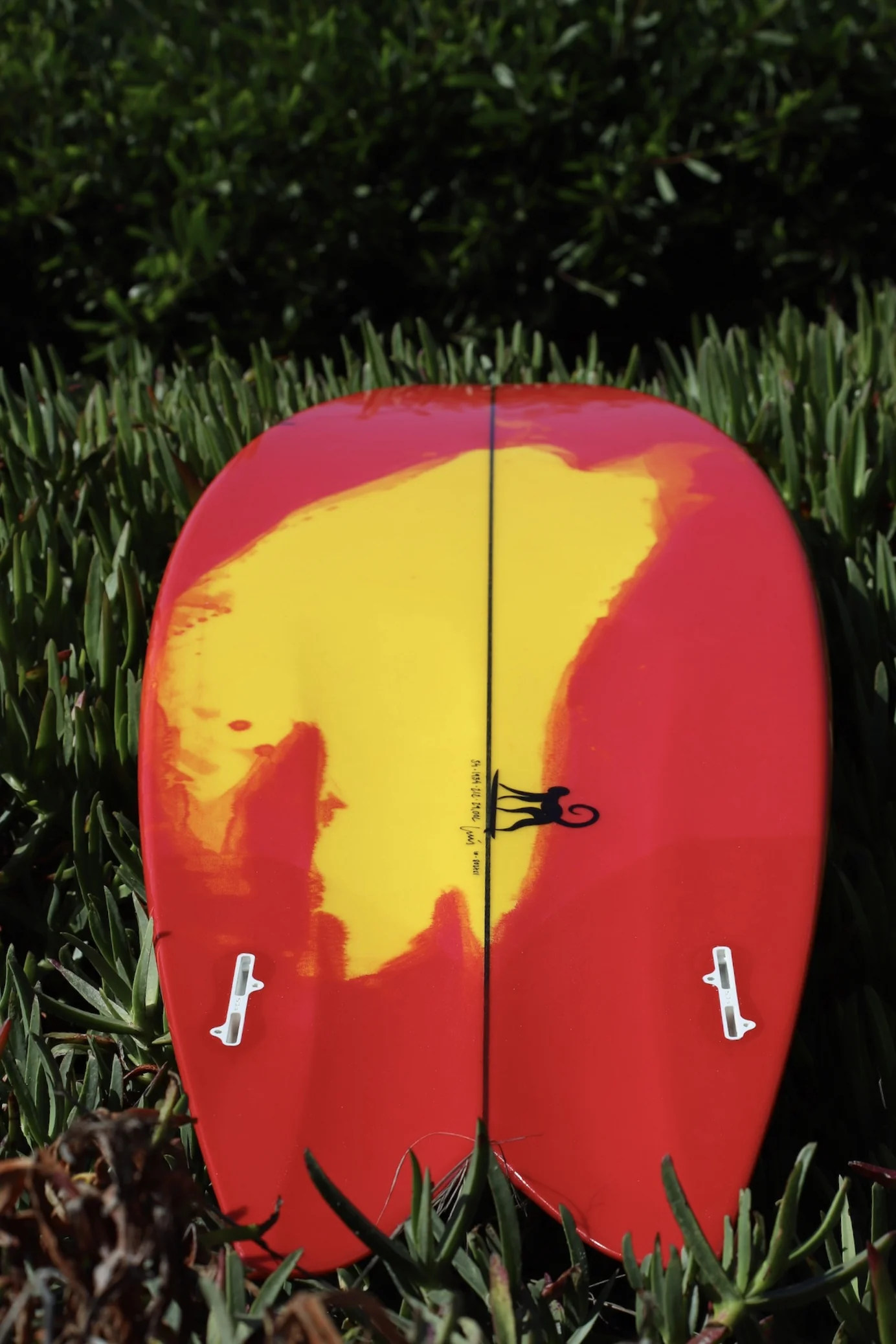 Red and yellow tinted resin poured across a twin-fin deck, handwritten dims and the Monkey Fly monkey logo on the stringer